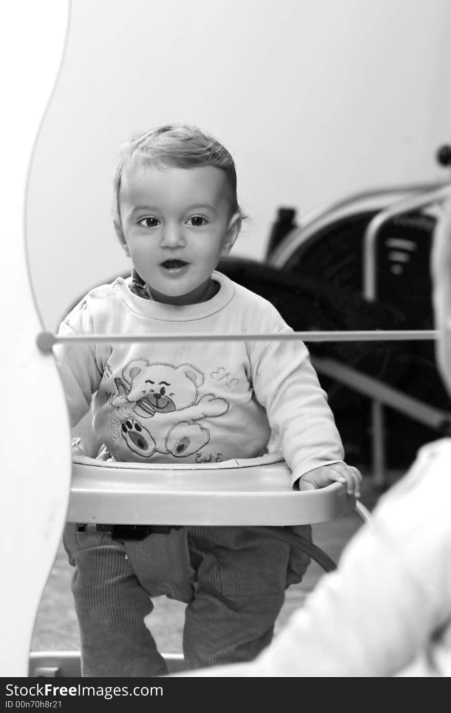 Small child smiling in the mirror (back and white). Small child smiling in the mirror (back and white)