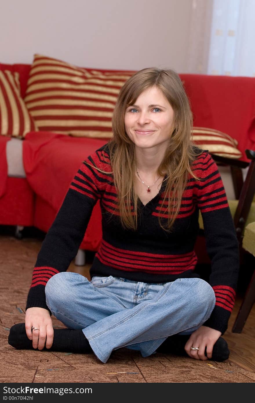 Smiling girl sitting on the floor portrait