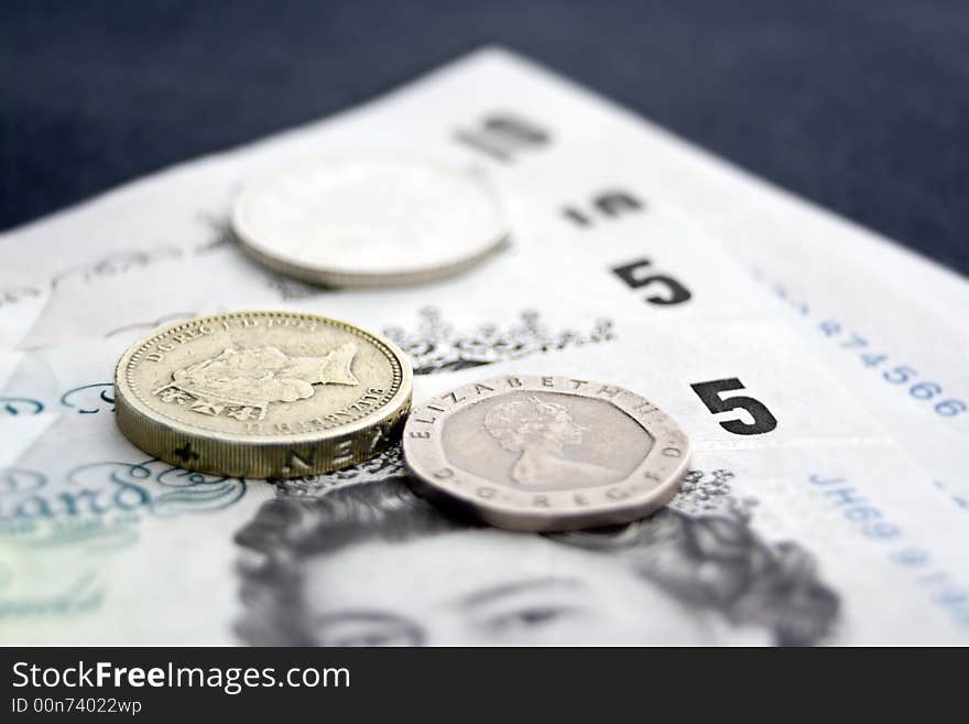 Cash & Coins with Depth of Field Effect. Focus on Pound Coin. Cash & Coins with Depth of Field Effect. Focus on Pound Coin