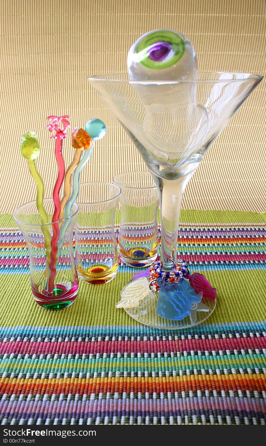 Martini Glass and Cocktail Sticks on a colorful placemat. Martini Glass and Cocktail Sticks on a colorful placemat