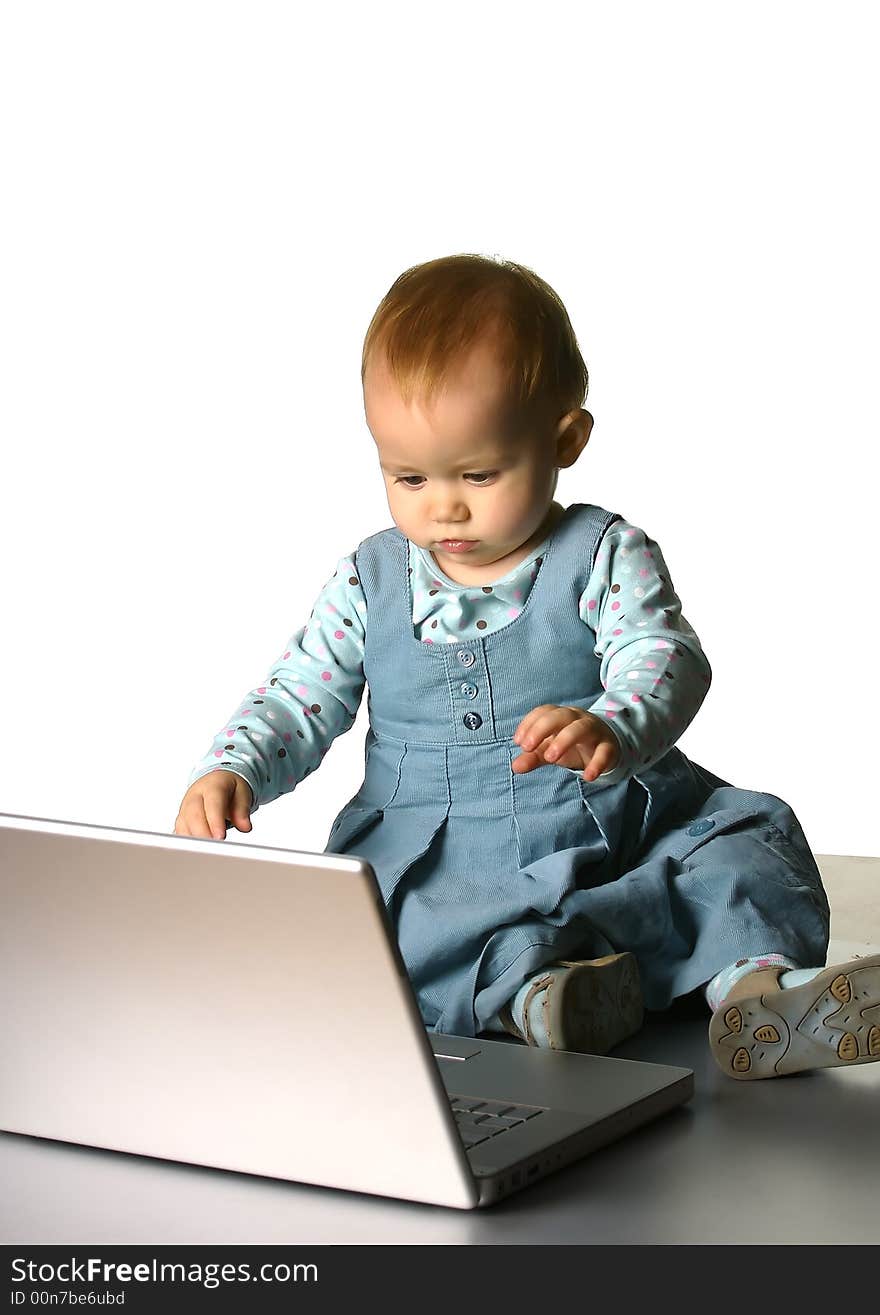 The little girl with a computer on a white background