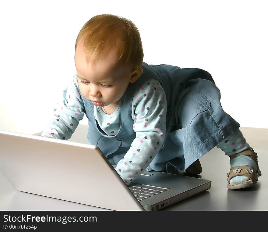 The little girl with a computer on a white background