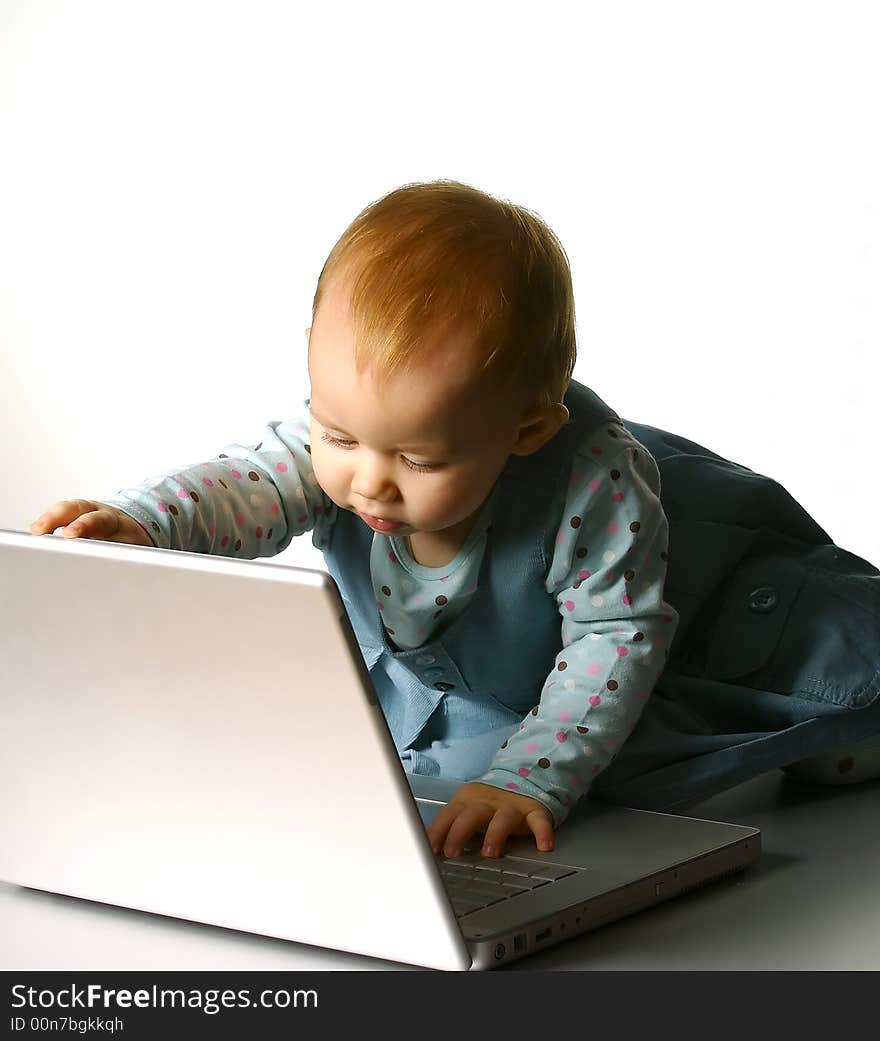 The little girl with a computer on a white background