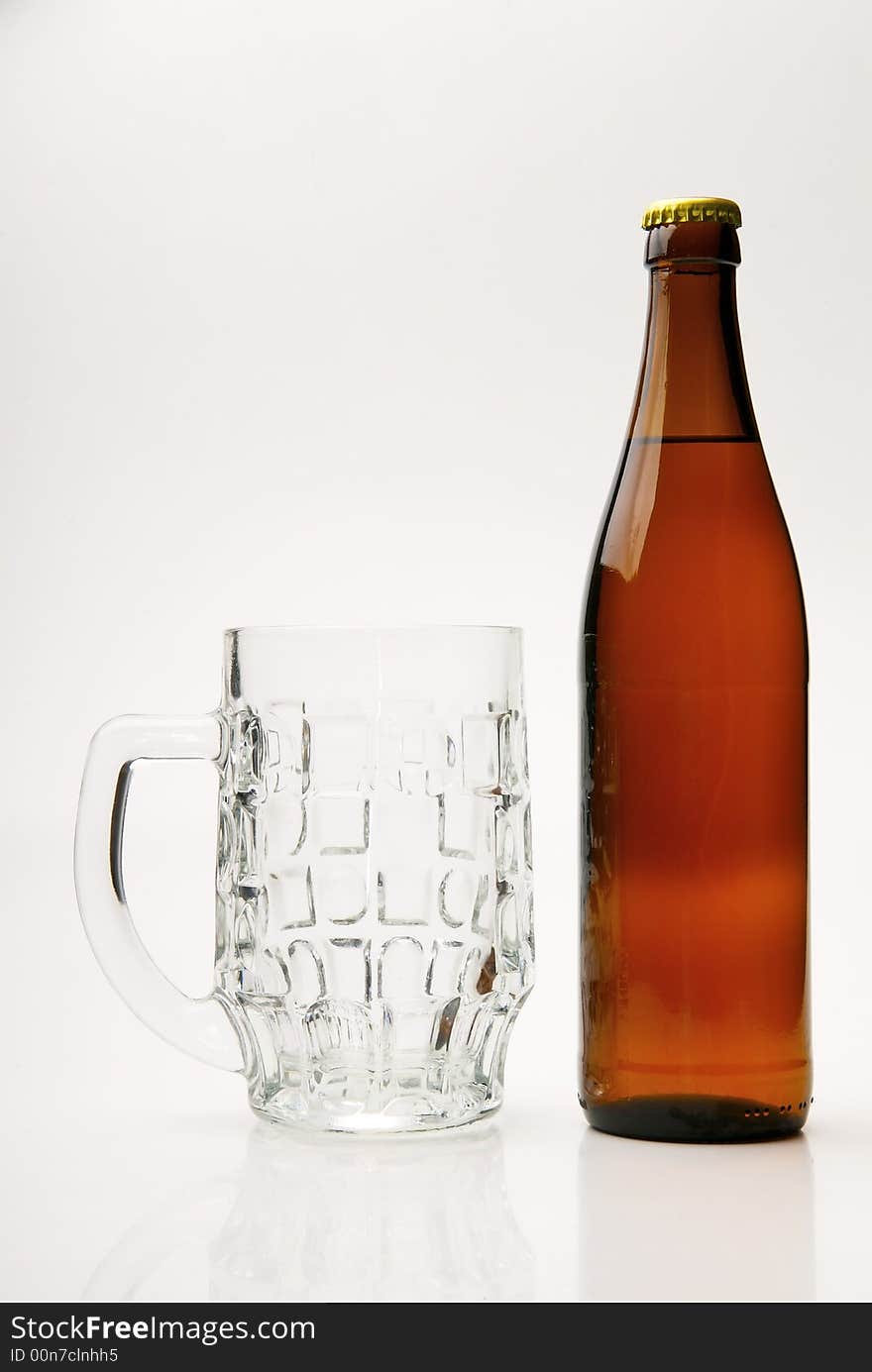 Fresh golden beer in a mug on a white background