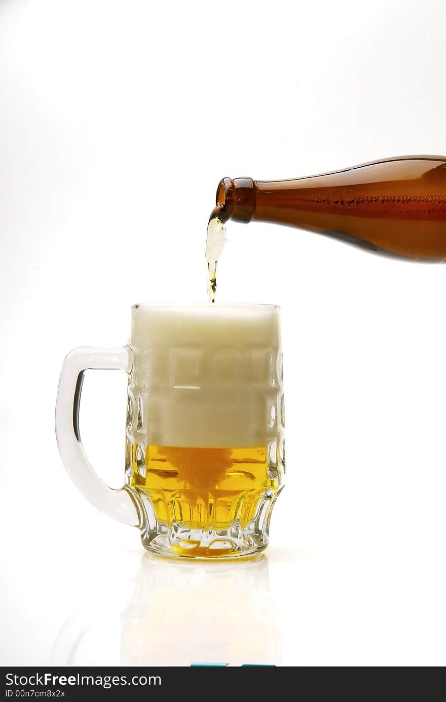 Fresh golden beer in a mug on a white background