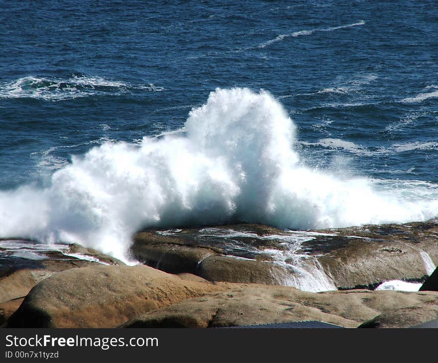 Waves crashing against rocks near Llandudno, Cape Town