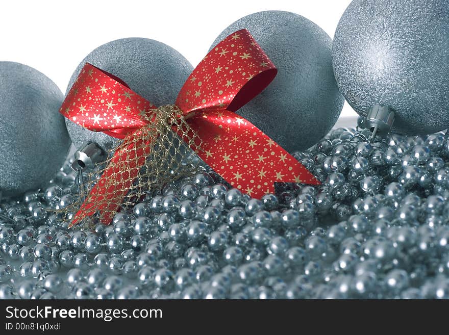 Silver christmas balls and red ribbon