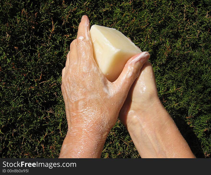 soapy hands on a green background