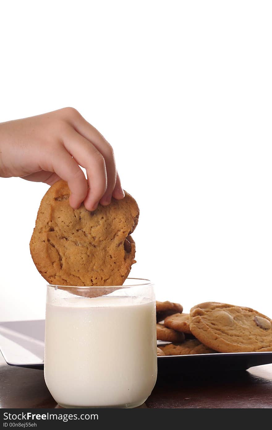 Shot of dipping cookie in milk upclose vertical