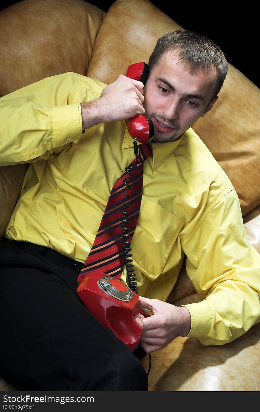 The man negotiates by the phone. The man negotiates by the phone