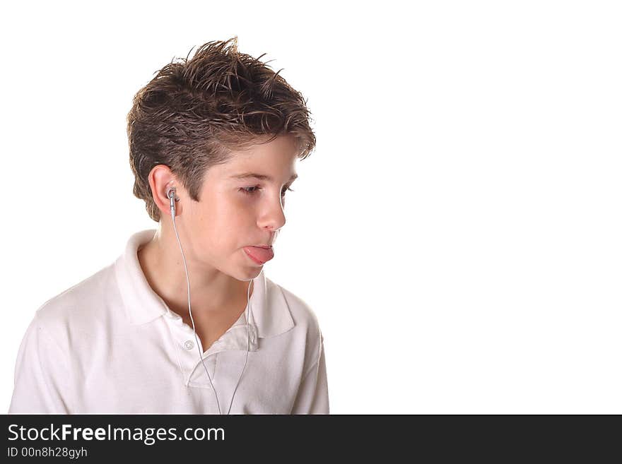 Young boy listening to music sticking out his tong