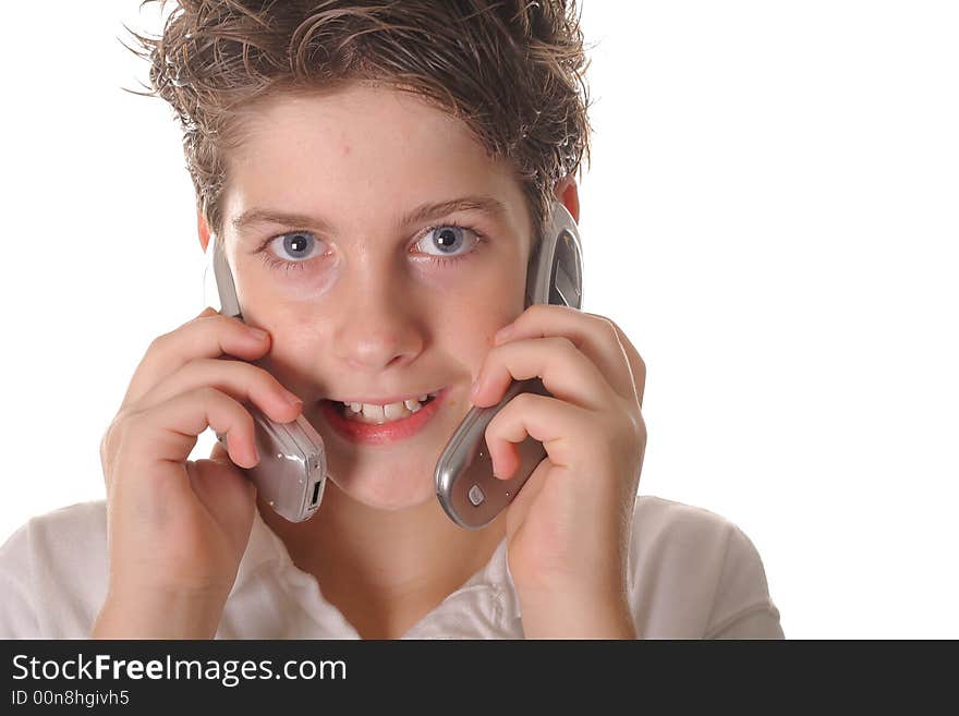 Shot of a young boy talking on two cell phones