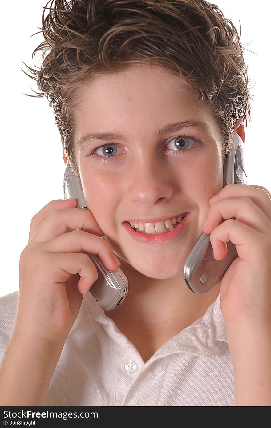 Shot of a young boy talking on two cell phones upclose vertical