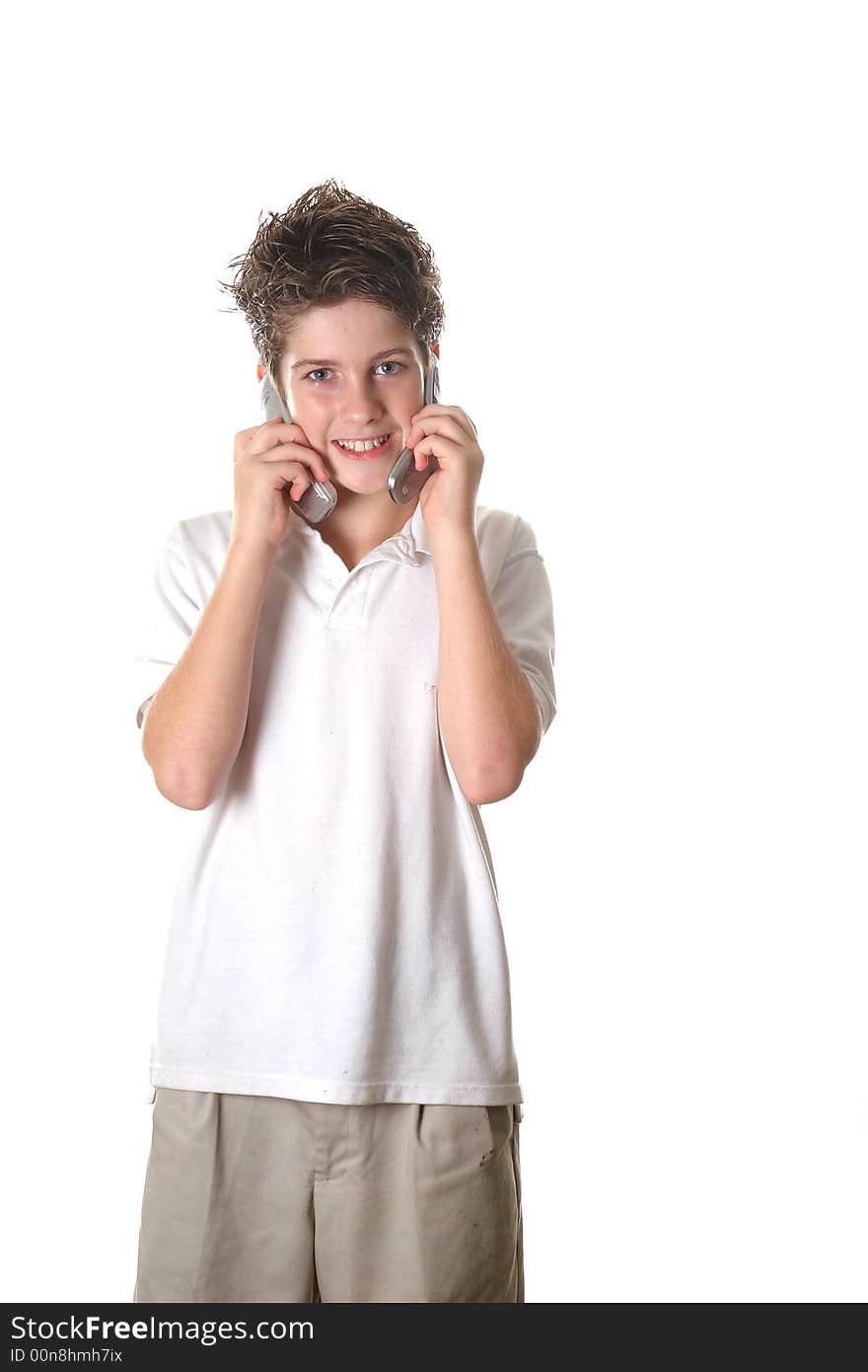 Shot of a young boy talking on two cell phones full shot