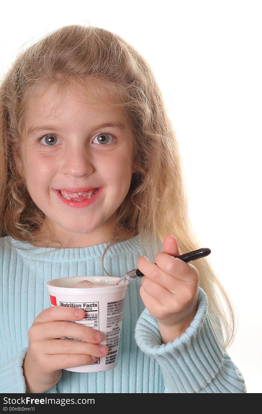 Shot of a happy little girl eating yogurt vertical