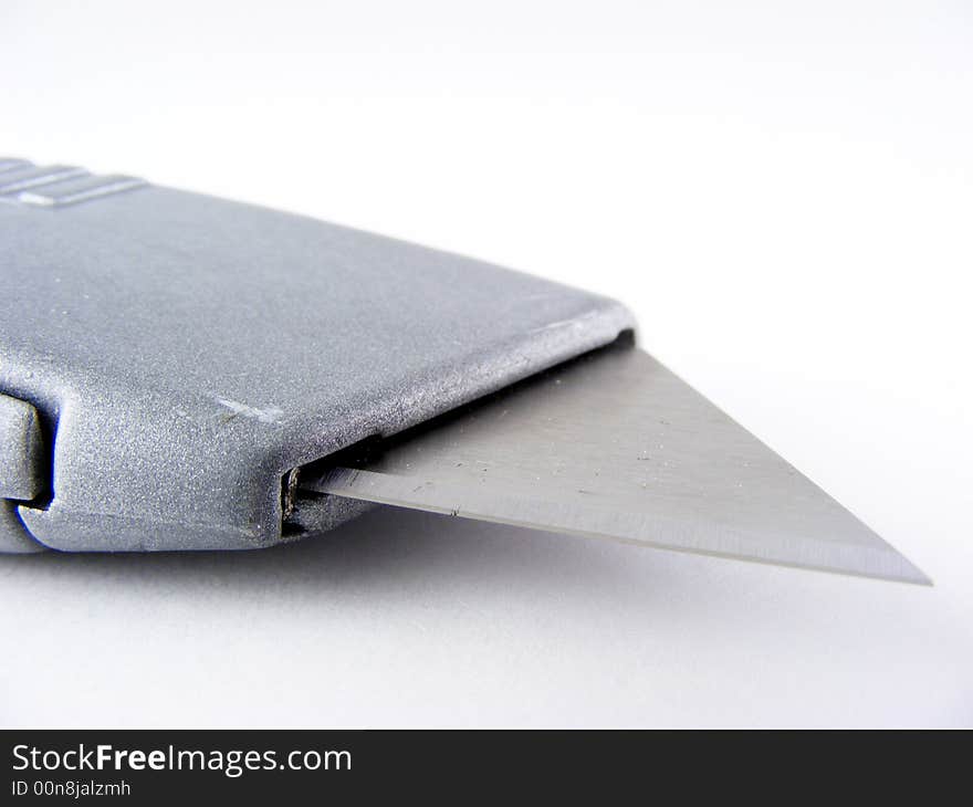 An utility knife against a white background. An utility knife against a white background.