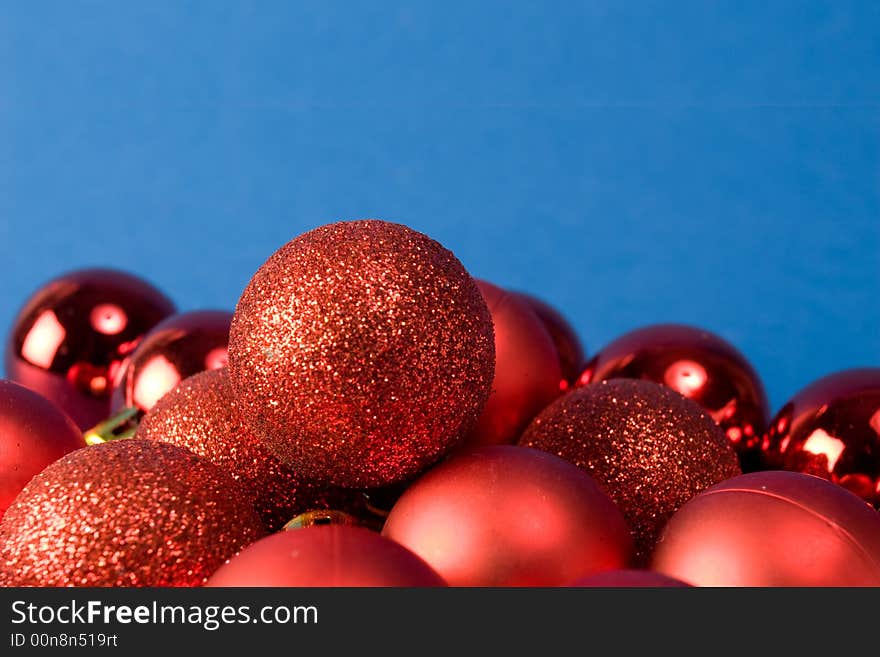 Red christmas globes close-up on blue background. Red christmas globes close-up on blue background