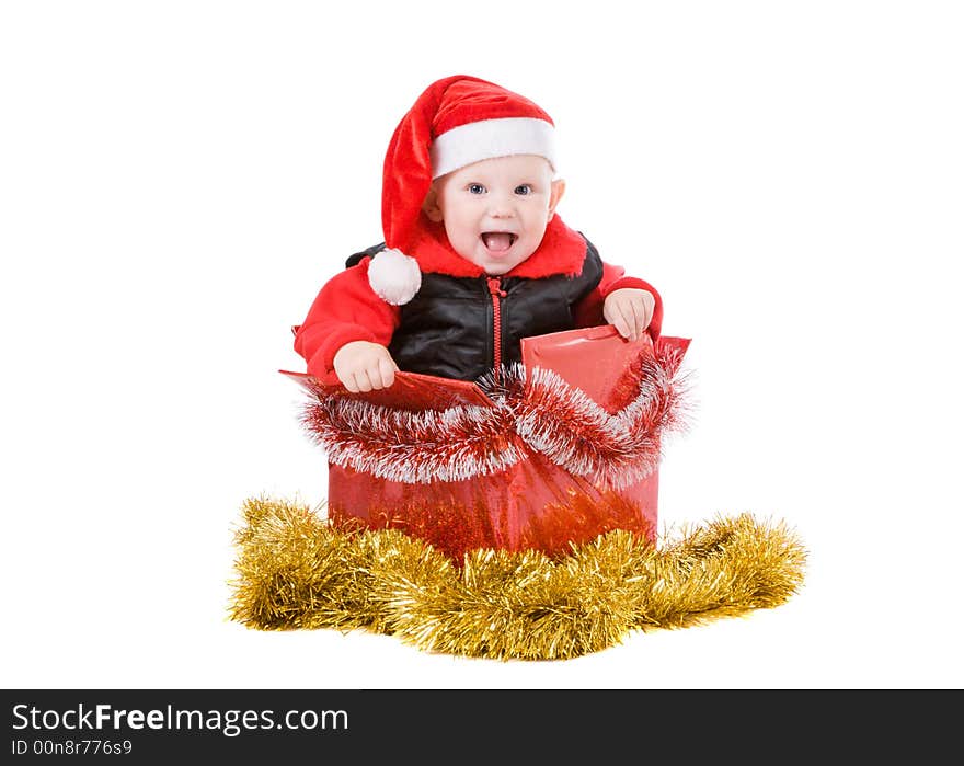 Happy infant with red cap in a decorated christmas box. Happy infant with red cap in a decorated christmas box