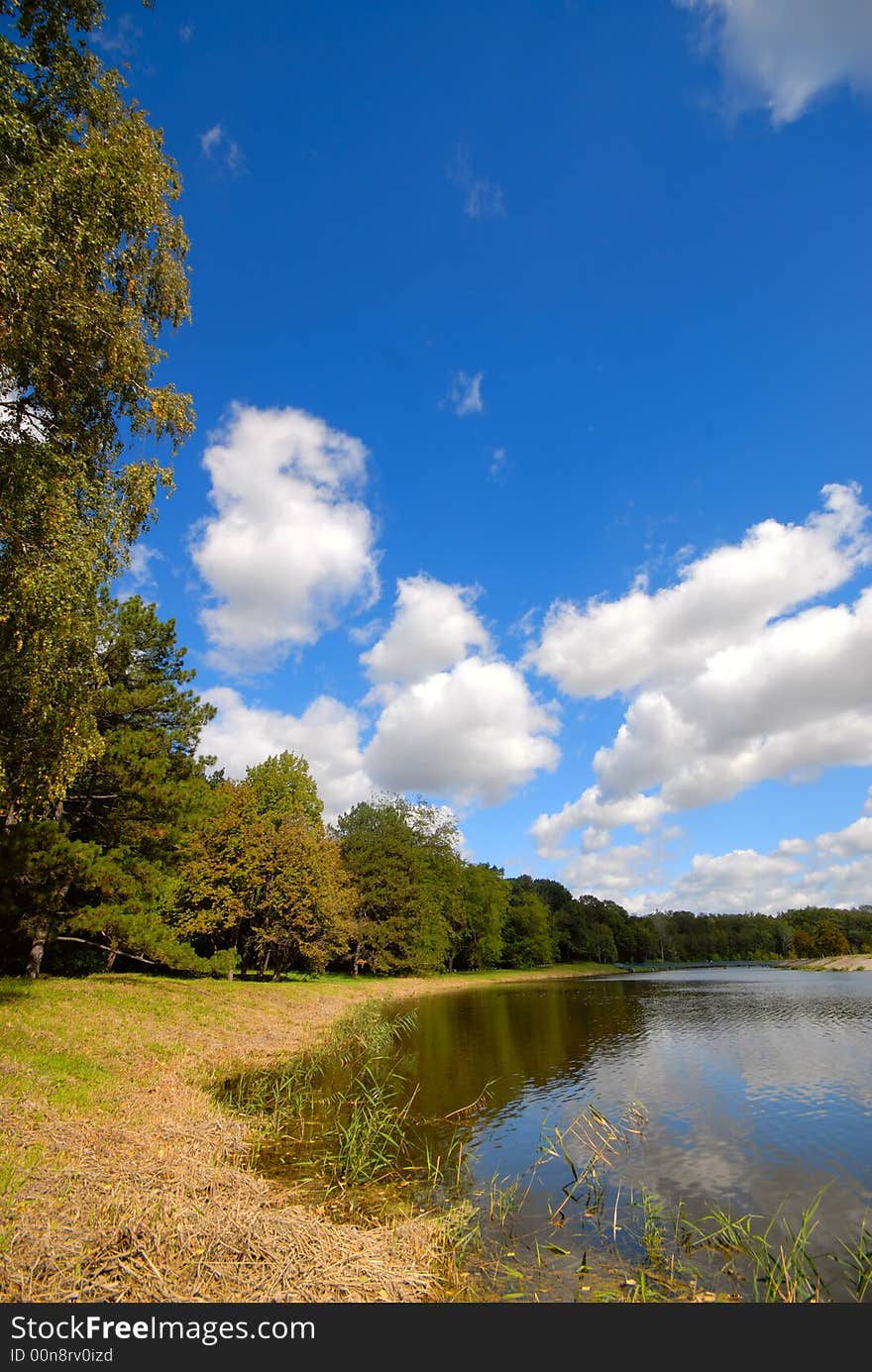 Summer landscape with white clouds on  background of  blue sky