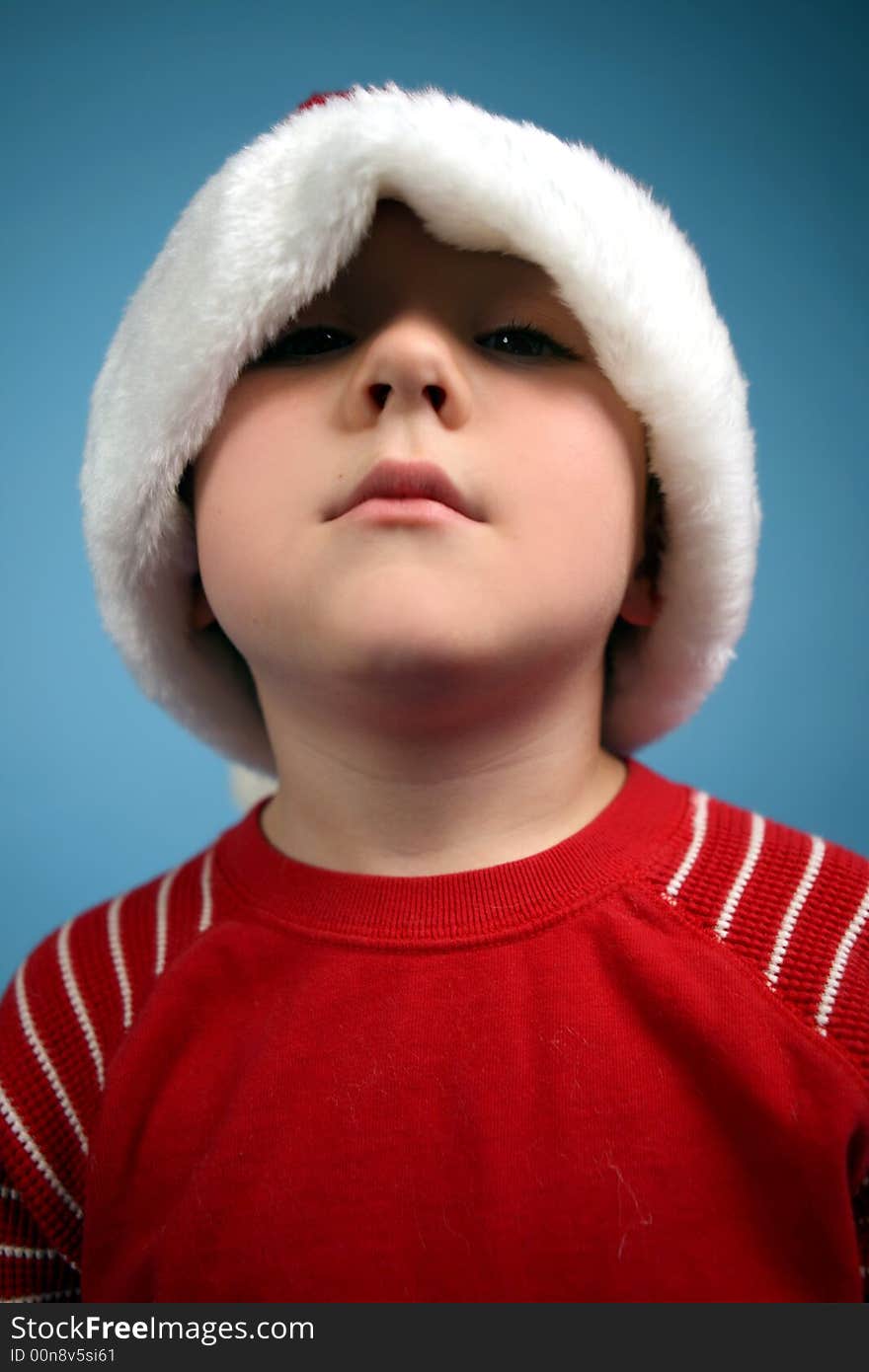 Young boy in an oversized santa hat