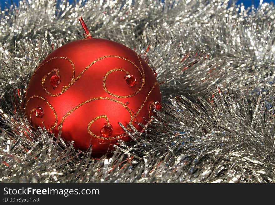 Round red christmas candle surrounded by winter silver. Round red christmas candle surrounded by winter silver