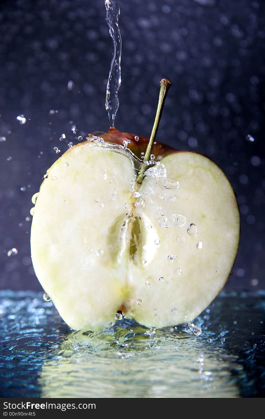 Half of juicy apple under the water