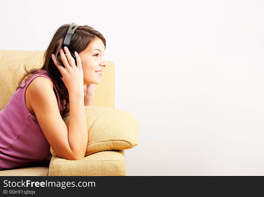 Young Girl enjoys listening music in headphones