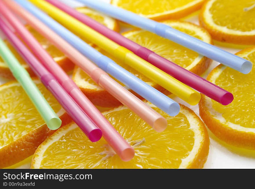 Straw on juicy citrus slices. Straw on juicy citrus slices