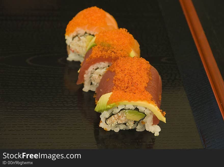 A series of sushi plates at an outdoor venue with a shallow depth of field. A series of sushi plates at an outdoor venue with a shallow depth of field