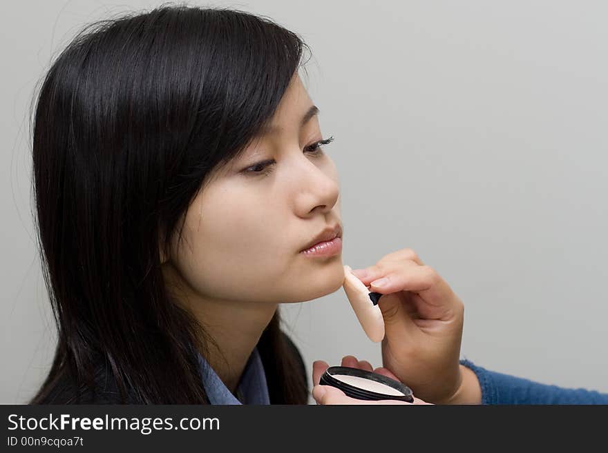 A girl was in process of fill-in makeup. A girl was in process of fill-in makeup