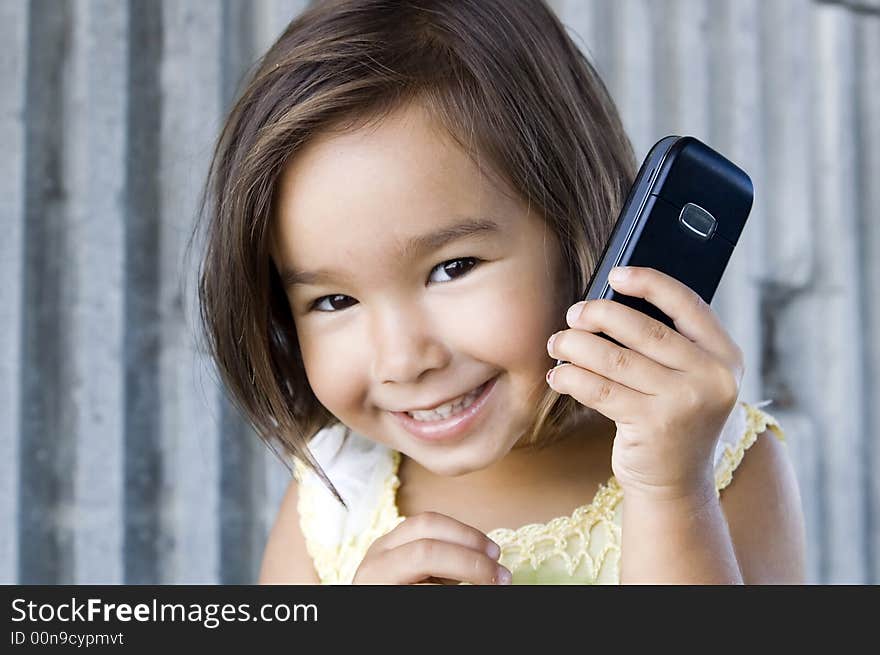 Little girl talking on the phone. Little girl talking on the phone