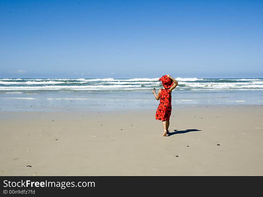 Girl in red dress on the beach. Girl in red dress on the beach