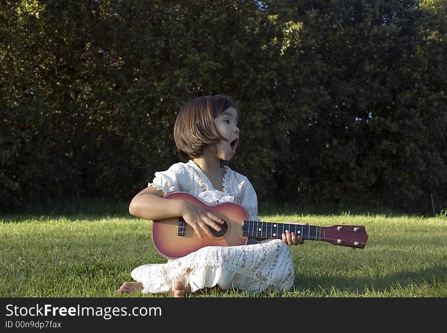 Girl with guitar on the lawn. Girl with guitar on the lawn