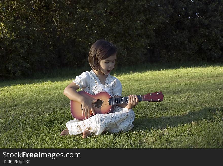 Girl with guitar on the lawn