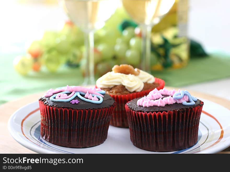 Fancy chocolate and carrot cake cupcakes with icing design on top