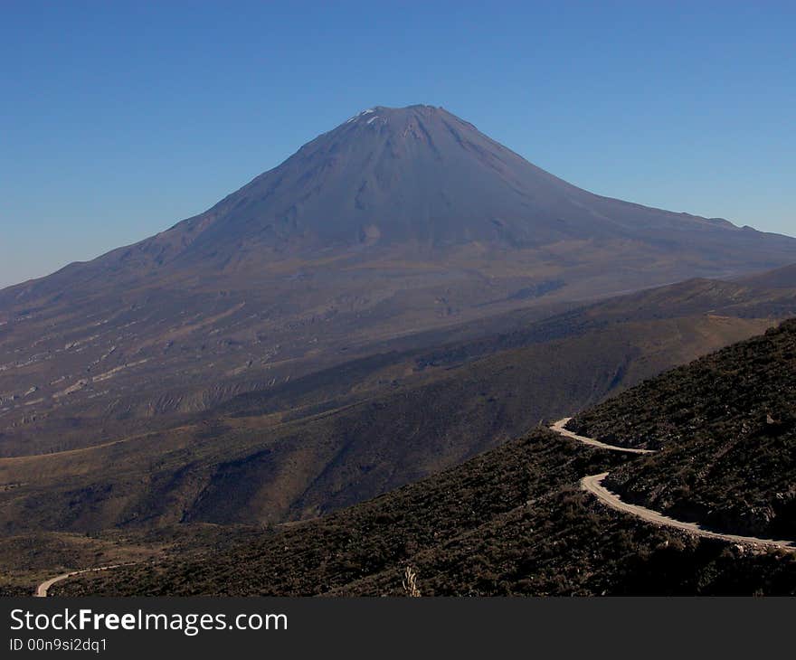 Perfectly cone-shaped El Mist volcano in Peru on a clear day. Perfectly cone-shaped El Mist volcano in Peru on a clear day.