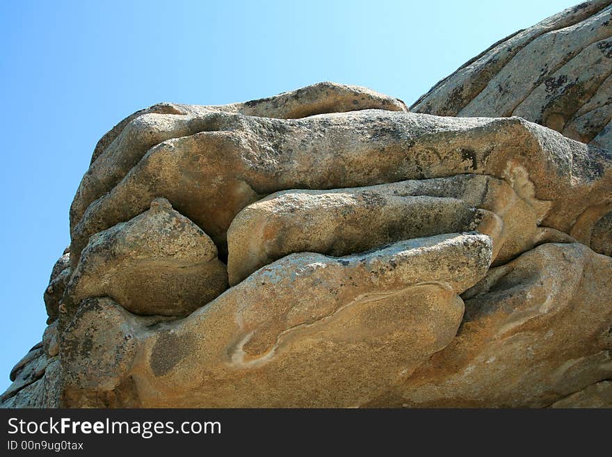 Part of a rock on a background of the sky. Part of a rock on a background of the sky