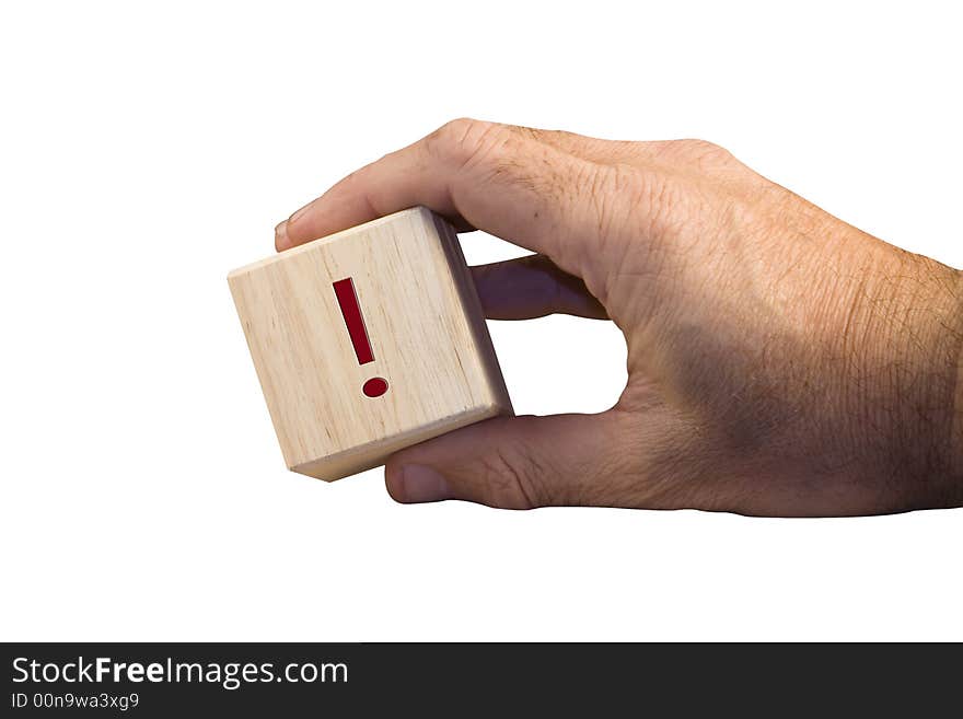 Single hand holding wooden block with exclamation sign