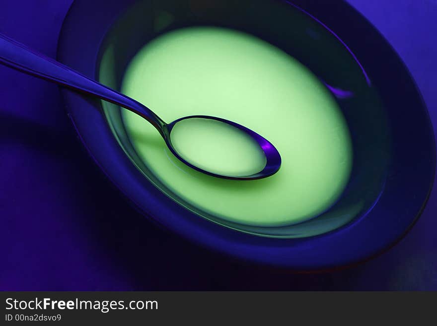 Plate and tablespoon over blue background