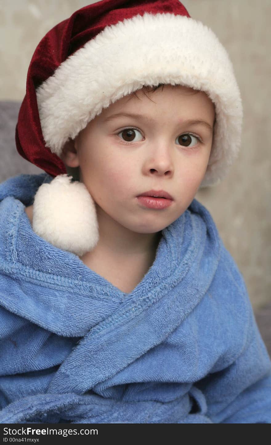 The nice boy in a New Year's cap on a white background