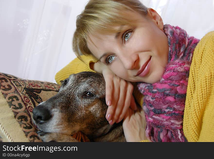 Girl sitting in chair and embrasing dog. Girl sitting in chair and embrasing dog