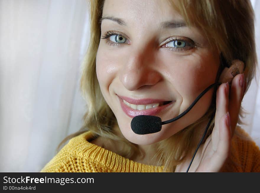 Smiling girl speaking on headphones. Smiling girl speaking on headphones