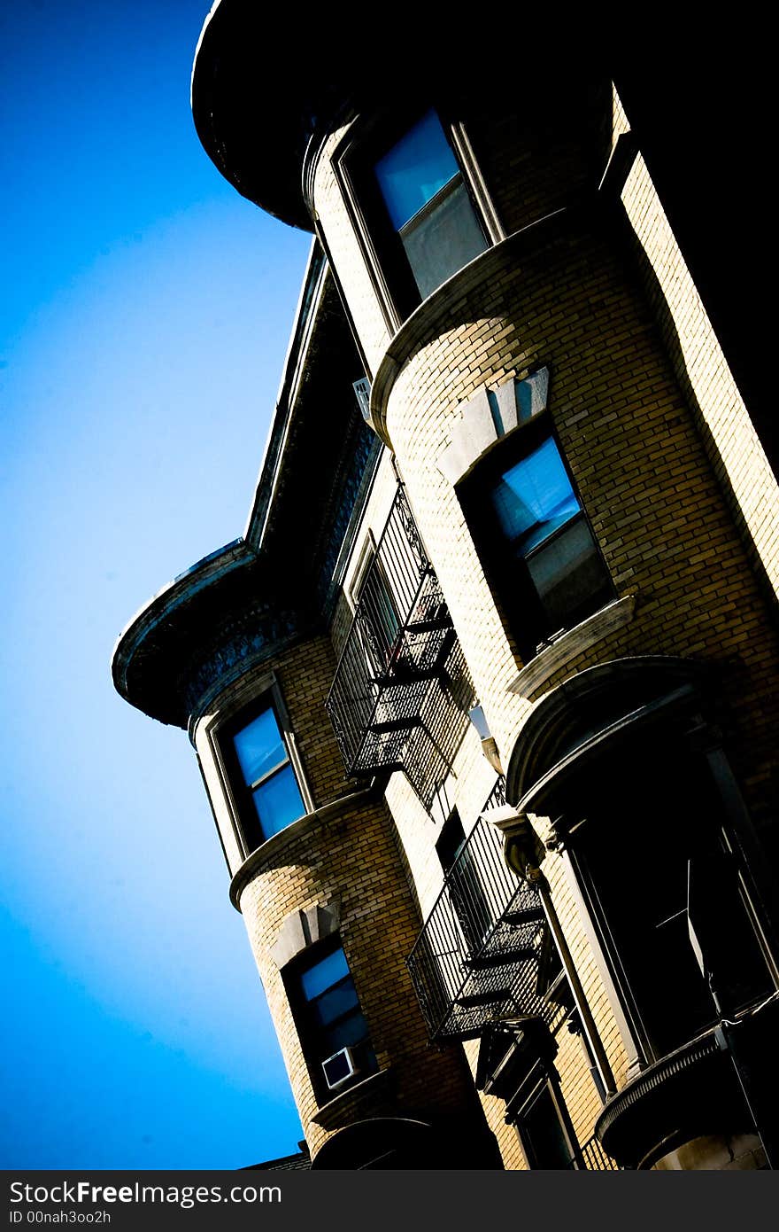 Brick building with bright blue background. Taken at slight angle. Brick building with bright blue background. Taken at slight angle