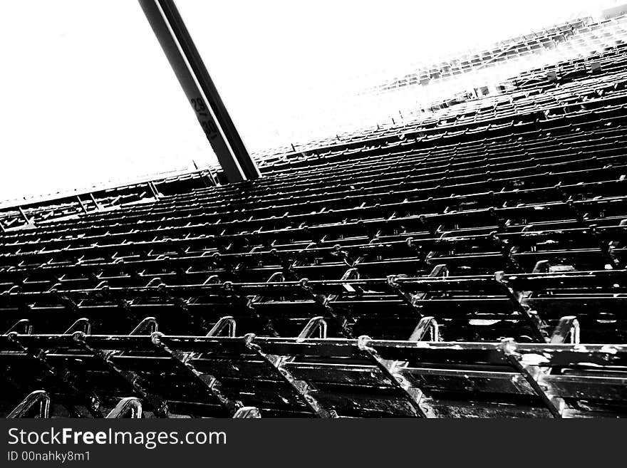 Stadium seats with a black and white treatment taken from a high angle from above