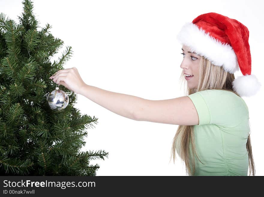 Woman fixing up christmas tree over white background