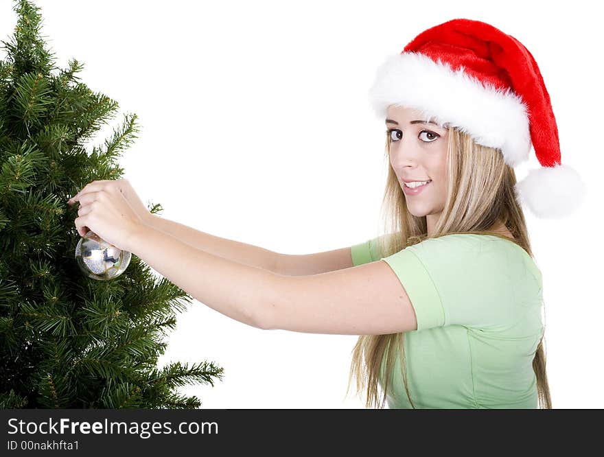 Woman fixing up christmas tree over white background