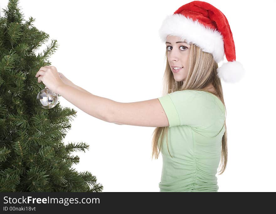 Woman fixing up christmas tree over white background