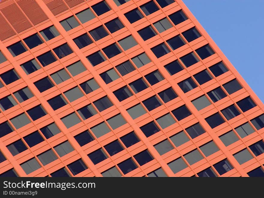 Red modern building of steel and concrete set against the blue sky. Red modern building of steel and concrete set against the blue sky