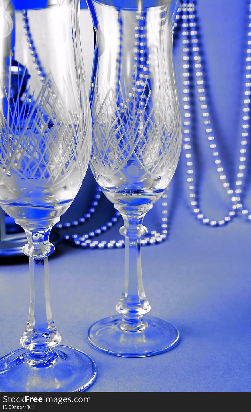 Two crystal glasses against the solemn dark-blue background. Two crystal glasses against the solemn dark-blue background