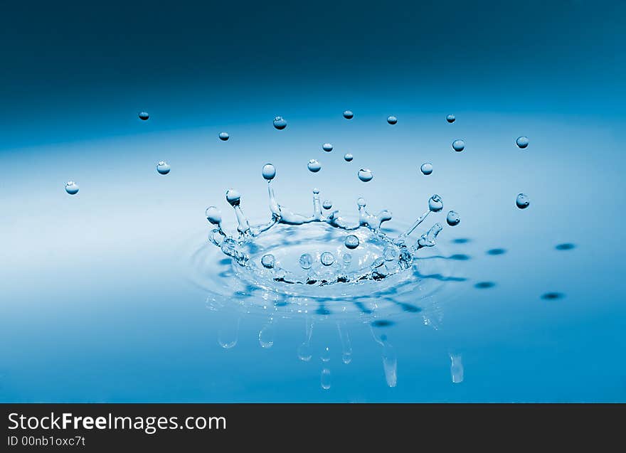 Blue crown waterdrop splashing on surface. Blue crown waterdrop splashing on surface